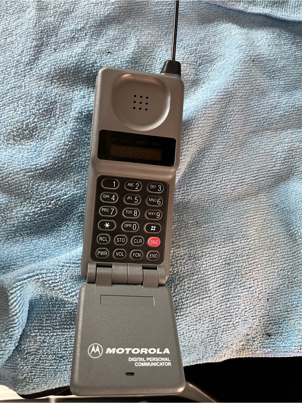 Motorola Silver Flip Phone with Numeric Keypad and Antenna